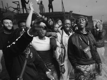 Movie still from “Pa Salieu feat. BackRoad Gee - My Family” (2020), directed by Femi Ladi – Medium shot, Low angle