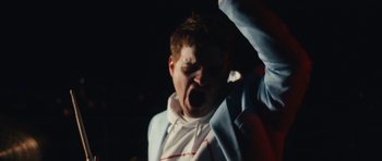 Movie still from “aexattack - Next Year” (2021), directed by Jetski – Close Up shot, Low angle