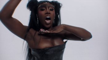 Movie still from “Bree Runway - Just Like That” (2024), directed by Pietro Biz Biasia – Close Up shot, Overhead angle