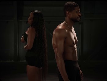 Movie still from “USHER, H.E.R. - Risk It All” (2024), directed by Dave Meyers – Medium shot, Over the shoulder angle