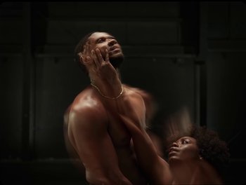 Movie still from “USHER, H.E.R. - Risk It All” (2024), directed by Dave Meyers – Medium shot, Low angle