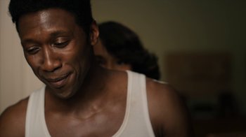 Movie still from “True Detective” (2014), created by Issa López – A person wearing a tank top; Close Up shot, Over the shoulder angle