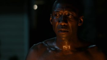 Movie still from “True Detective” (2014), created by Issa López – A person in a dark room; Close Up shot, Low angle