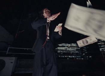 Movie still from “Sam Akpro - Death By Entertainment” (2023), directed by Pedro Takahashi – Medium shot, Low angle