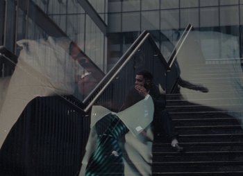 Movie still from “Sam Akpro - Death By Entertainment” (2023), directed by Pedro Takahashi – Medium shot, Low angle