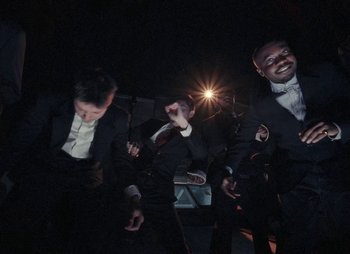 Movie still from “Sam Akpro - Death By Entertainment” (2023), directed by Pedro Takahashi – Medium shot, Low angle