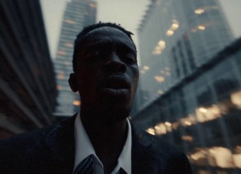 Movie still from “Sam Akpro - Death By Entertainment” (2023), directed by Pedro Takahashi – Extreme Close Up shot, Low angle