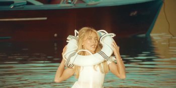 Movie still from “Sabrina Carpenter - Espresso” (2024), directed by Dave Meyers – Medium shot, Low angle