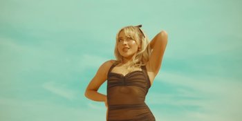 Movie still from “Sabrina Carpenter - Espresso” (2024), directed by Dave Meyers – Medium shot, Low angle