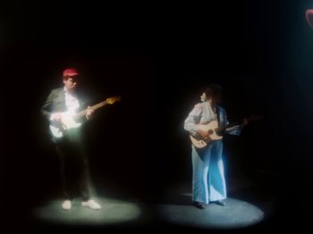 Movie still from “Metronomy & Katy J Pearson's - Love Factory” (2022), directed by Ned Botwood – Medium shot, Low angle