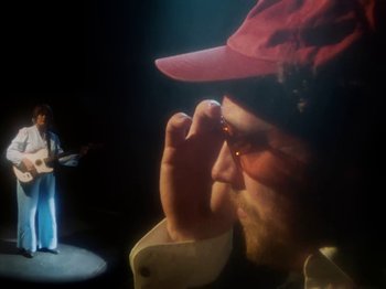 Movie still from “Metronomy & Katy J Pearson's - Love Factory” (2022), directed by Ned Botwood – Medium shot, Low angle