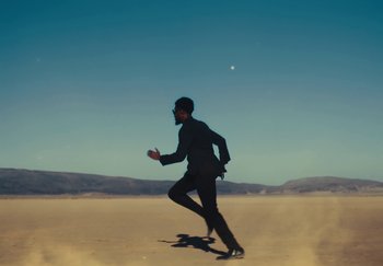 Movie still from “Sheck Wes, JID & Ski Mask The Slump God - Fly Away” (2024), directed by Cole Bennett – Wide shot, Low angle