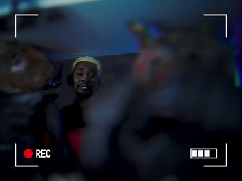 Movie still from “Danny Brown feat. Bruiser Wolf - Y.B.P.” (2024), directed by Edem Wornoo – Extreme Close Up shot, Over the shoulder angle