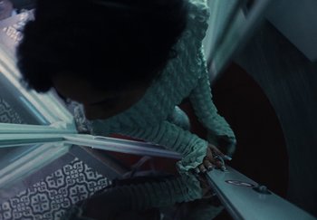 Movie still from “AJ Tracey - Bubble Bath” (2024), directed by Late Milk – Extreme Close Up shot, Overhead angle