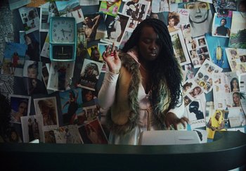 Movie still from “AJ Tracey - Bubble Bath” (2024), directed by Late Milk – Medium shot, High angle