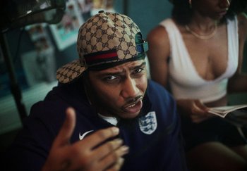 Movie still from “AJ Tracey - Bubble Bath” (2024), directed by Late Milk – Close Up shot, Over the shoulder angle