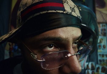 Movie still from “AJ Tracey - Bubble Bath” (2024), directed by Late Milk – Extreme Close Up shot, Low angle