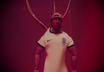 Movie still from “AJ Tracey - Bubble Bath” (2024), directed by Late Milk – Medium shot, Over the shoulder angle