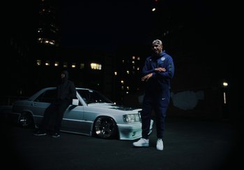 Movie still from “AJ Tracey - Bubble Bath” (2024), directed by Late Milk – Wide shot, Low angle