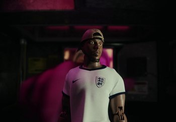 Movie still from “AJ Tracey - Bubble Bath” (2024), directed by Late Milk – Medium shot, Low angle