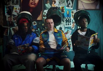 Movie still from “AJ Tracey - Bubble Bath” (2024), directed by Late Milk – Medium shot, Low angle