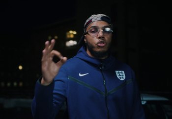 Movie still from “AJ Tracey - Bubble Bath” (2024), directed by Late Milk – Close Up shot, Low angle