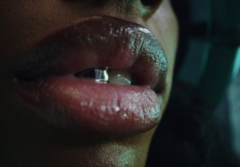 Movie still from “AJ Tracey - Bubble Bath” (2024), directed by Late Milk – Extreme Close Up shot, Low angle