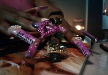 Movie still from “AJ Tracey - Bubble Bath” (2024), directed by Late Milk – Extreme Close Up shot, Overhead angle