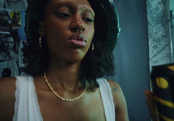 Movie still from “AJ Tracey - Bubble Bath” (2024), directed by Late Milk – Close Up shot, Low angle