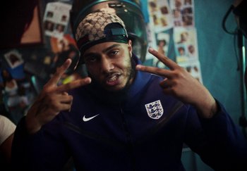 Movie still from “AJ Tracey - Bubble Bath” (2024), directed by Late Milk – Close Up shot, High angle