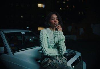 Movie still from “AJ Tracey - Bubble Bath” (2024), directed by Late Milk – Medium shot, Low angle