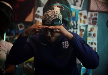 Movie still from “AJ Tracey - Bubble Bath” (2024), directed by Late Milk – Medium shot, High angle