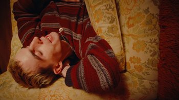 Movie still from “Conswank - Holes In My Denim” (2023), directed by Seamus Brennan – Medium shot, Overhead angle