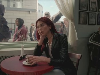 Movie still from “Dua Lipa - Training Season” (2024), directed by Vincent Haycock – Medium shot, Over the shoulder angle