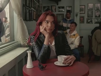 Movie still from “Dua Lipa - Training Season” (2024), directed by Vincent Haycock – Medium shot, Over the shoulder angle
