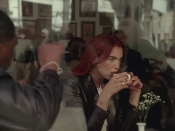 Movie still from “Dua Lipa - Training Season” (2024), directed by Vincent Haycock – Medium shot, Over the shoulder angle