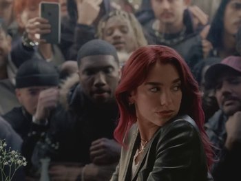 Movie still from “Dua Lipa - Training Season” (2024), directed by Vincent Haycock – Medium shot, Over the shoulder angle