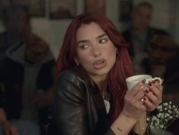 Movie still from “Dua Lipa - Training Season” (2024), directed by Vincent Haycock – Close Up shot, Over the shoulder angle