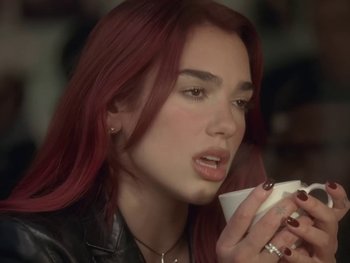 Movie still from “Dua Lipa - Training Season” (2024), directed by Vincent Haycock – Close Up shot, Over the shoulder angle