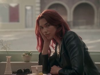 Movie still from “Dua Lipa - Training Season” (2024), directed by Vincent Haycock – Medium shot, Over the shoulder angle