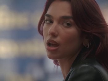 Movie still from “Dua Lipa - Training Season” (2024), directed by Vincent Haycock – Close Up shot, Over the shoulder angle