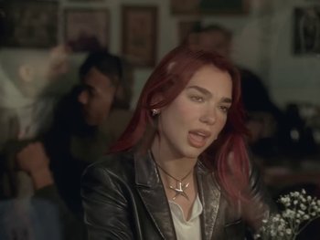 Movie still from “Dua Lipa - Training Season” (2024), directed by Vincent Haycock – Close Up shot, Over the shoulder angle