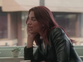 Movie still from “Dua Lipa - Training Season” (2024), directed by Vincent Haycock – Close Up shot, Over the shoulder angle