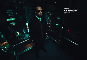 Movie still from “AJ Tracey - Wifey Riddim 4” (2024), directed by Late Milk – Medium shot, Overhead angle