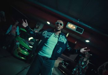 Movie still from “AJ Tracey - Wifey Riddim 4” (2024), directed by Late Milk – Medium shot, Low angle