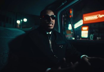 Movie still from “AJ Tracey - Wifey Riddim 4” (2024), directed by Late Milk – Medium shot, Low angle