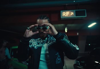 Movie still from “AJ Tracey - Wifey Riddim 4” (2024), directed by Late Milk – Medium shot, Low angle