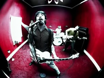 Movie still from “Foo Fighters - Monkey Wrench” (2009), directed by Dave Grohl – Medium shot, Overhead angle