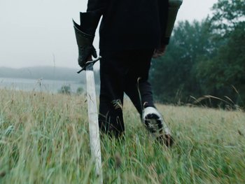 Movie still from “Killdummies - Keine War Großartig//Fukk U” (2023), directed by Tom Klimek – Medium shot, Low angle