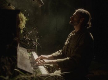 Movie still from “Hayden Thorpe - Aerial Songs” (2021), directed by Fiona Jane Burgess – Medium shot, Low angle
